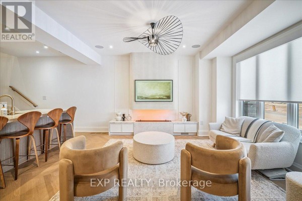 Cozy seating area with two chairs, large window, and contemporary decor - 3266 Sixth Line, Oakville