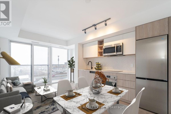 Bedroom with a king-sized bed, large window, and city view. - 327 - 36 Zorra Street, Toronto