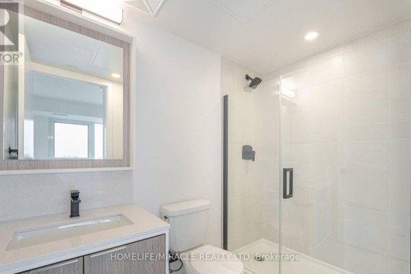 Bedroom with a queen-sized bed, nightstand, and a closet with sliding doors. - 327 - 36 Zorra Street, Toronto