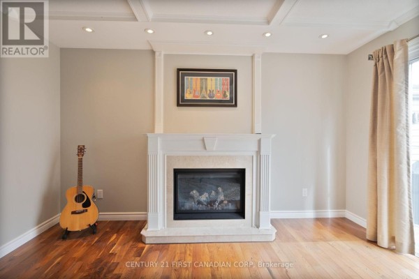 Wooden deck with built-in benches facing the beige brick paved patio area. - 327 Everglade Crescent, London North