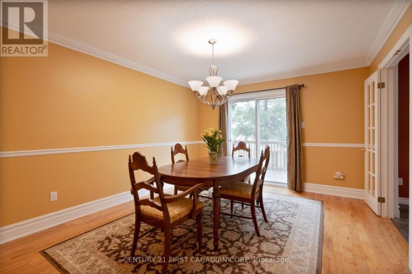 Wooden deck with wooden fence and the front door of the townhouse. - 327 Everglade Crescent, London North