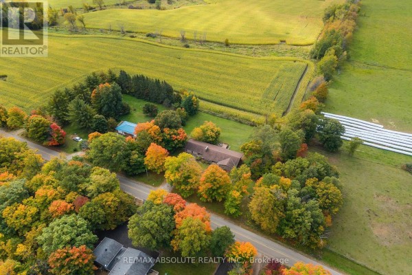 Aerial view of a property with a house, pool, and fields surrounded by autumn foliage. - 327 Nieman Drive, Mcnab/braeside