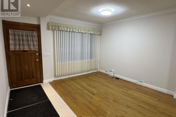 Empty room with beige tile floors, white trim, and a window with blinds. - 327 Springdale Boulevard, Toronto