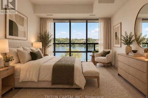 Primary bedroom with a king-size bed, dresser, and large window overlooking a body of water. - 328 - 350 Prince Charles Drive S, Welland