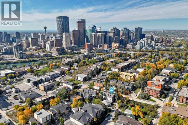 Aerial view of townhouses with Calgary skyline in the background on a sunny day. - 328 3 Street Ne, Calgary