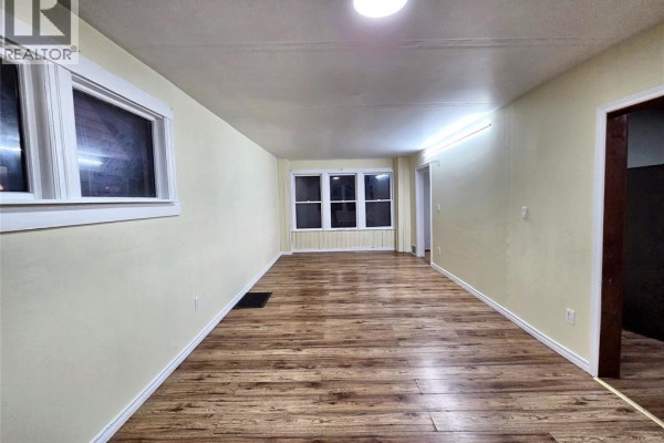 Attic bedroom with wooden plank walls and ceiling, and wooden floors. - 328 John B Avenue, Windsor