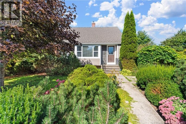 Exterior of the house with stone and siding, surrounded by trees and bushes. - 3281 Mountain Road, Lutes Mountain