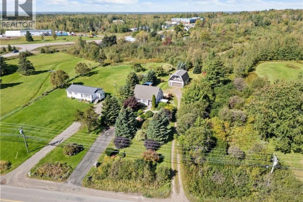 Aerial view of the property including two homes, a garage, and surrounding landscape. - 3281 Mountain Road, Lutes Mountain