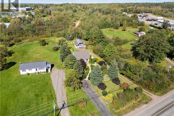 Aerial view of the property with two houses, a barn-style garage, and extensive grounds. - 3281 Mountain Road, Lutes Mountain