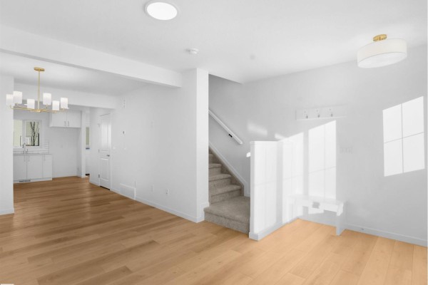 Dining area with pendant lighting, hardwood floors, and view of kitchen - #33 1009 Cy Becker Rd Nw, Edmonton