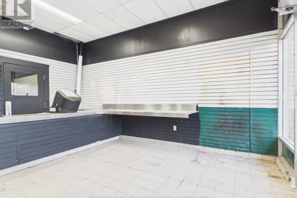 Interior view showing a slatted wall, metal counter, and tiled floor. - 33 Argyle Street, Grey Highlands