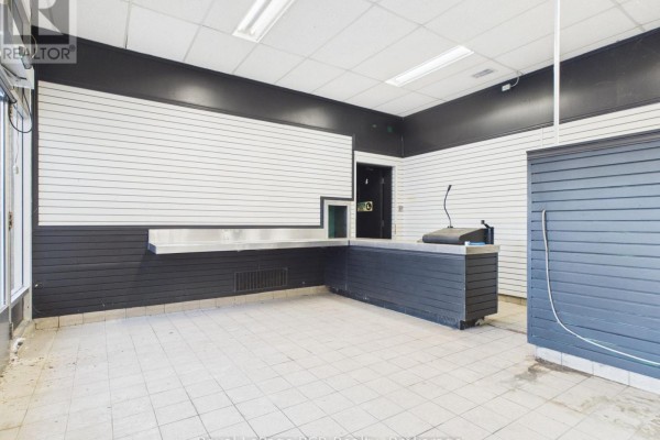 Interior view with slatted walls, counter, and tiled floor, facing a doorway. - 33 Argyle Street, Grey Highlands