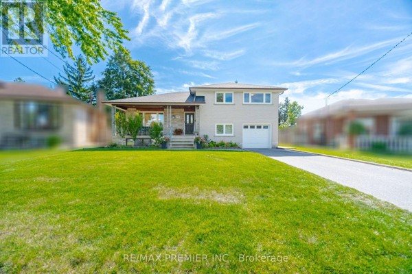 Wide front exterior view of the residential property at 33 Belleglade Court with green lawn and driveway. - 33 Belleglade Court, Toronto