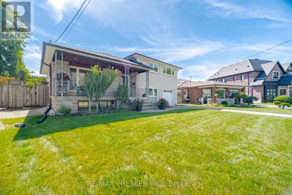 Side exterior view of the house showing brick siding, lawn, and neighbors. - 33 Belleglade Court, Toronto