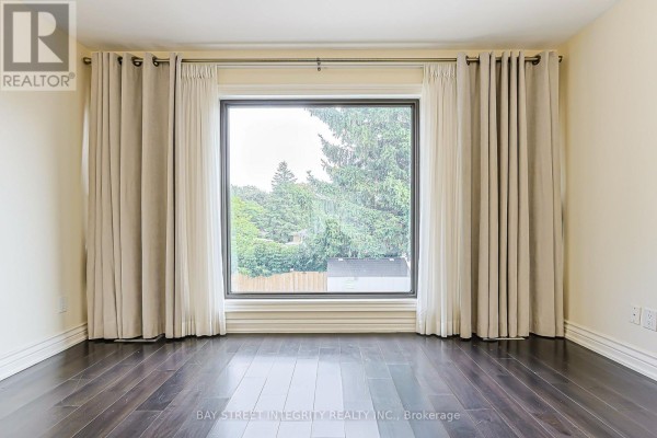 Large window with curtains and hardwood floors - 33 Deerford Road Toronto