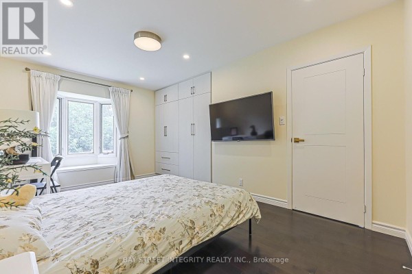 Bedroom with bay window, built-in wardrobe, and wall-mounted TV - 33 Deerford Road Toronto