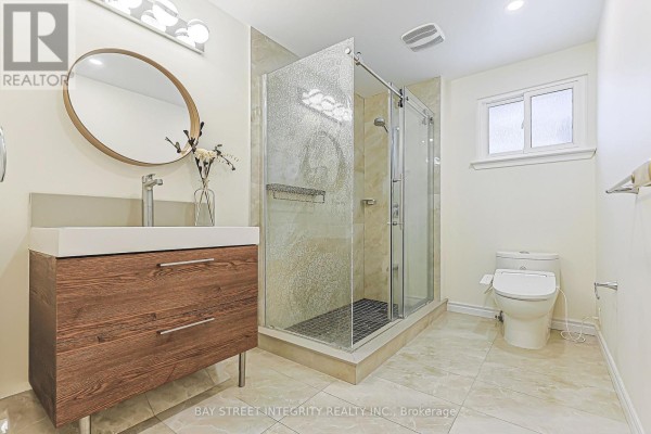 Modern bathroom with floating vanity, glass shower, and bidet toilet seat - 33 Deerford Road Toronto