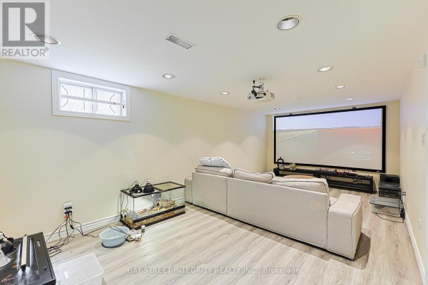 Home theater basement with projector, screen, sofa, and aquarium - 33 Deerford Road Toronto