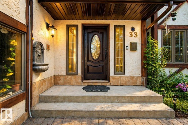 Close-up of the front entrance with a dark wood door, sidelights, and address number 33. - 33 Glen Meadow Cr, St  Albert