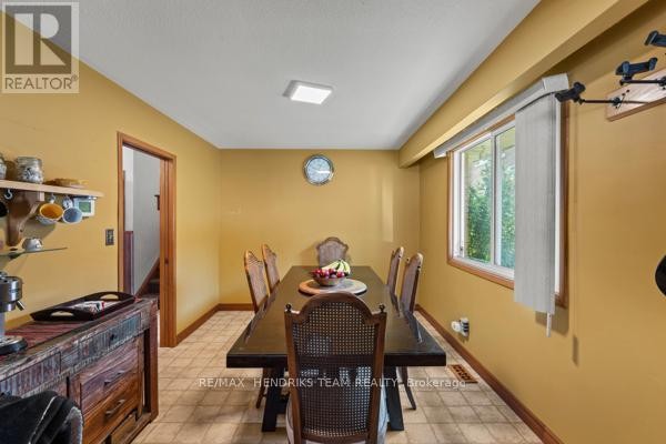 Dining room with dark wood table, wicker chairs, and buffet - 33 Meadowbrook Crescent St  Catharines
