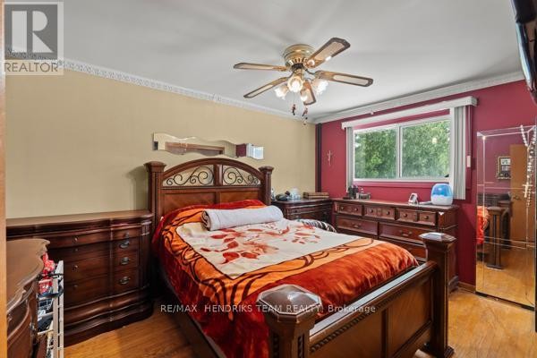 Bedroom with wooden furniture and ceiling fan - 33 Meadowbrook Crescent St Catharines