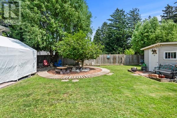 Backyard with picnic table, shed, bench, fire pit, and tree - 33 Meadowbrook Crescent St  Catharines