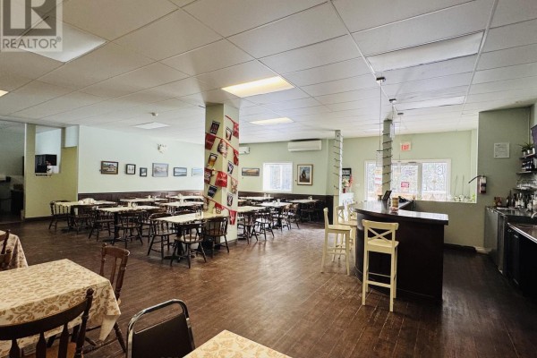 Dining area featuring multiple tables, bar counter, and decorative wall - 33 Queen St Street, North Stormont