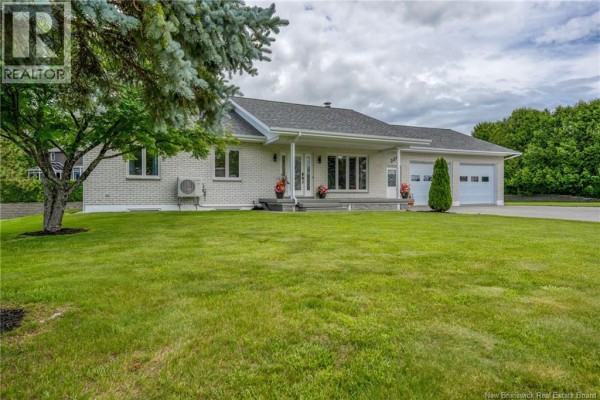 Wide shot of the house at 330 Guay Street, showing the paved driveway and front entrance. - 330 Guay Street, Grand Sault/grand Falls