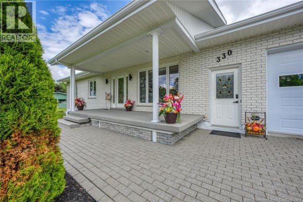 The property at 330 Guay Street includes a house, a detached garage, and a black pickup truck. - 330 Guay Street, Grand Sault/grand Falls