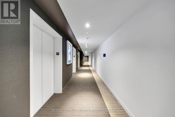 Balcony with glass railings overlooking a city skyline, featuring sliding glass doors to the interior. - 3301 - 3900 Confederation Parkway, Mississauga