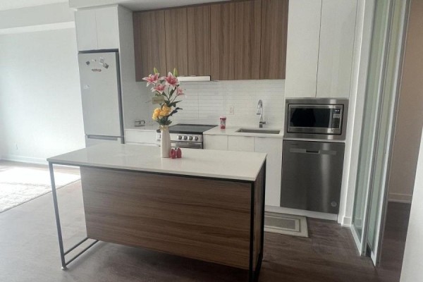 Kitchen with white countertops, wood cabinets, stainless steel appliances, and an island. - 3303 - 30 Upper Mall Way, Vaughan