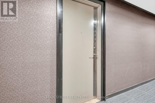 Apartment door labeled 3303 with beige wallpaper and dark trim. - 3303 - 70 Town Centre Court, Toronto