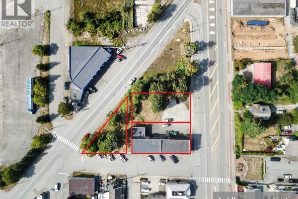 Aerial view showing a triangular lot with two interconnected commercial buildings and surrounding roads. - 3304 3rd Ave, Port Alberni