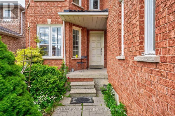 Close-up view of the front entrance with stone steps, a covered porch, and a white front door. - 3309 Loyalist Drive, Mississauga