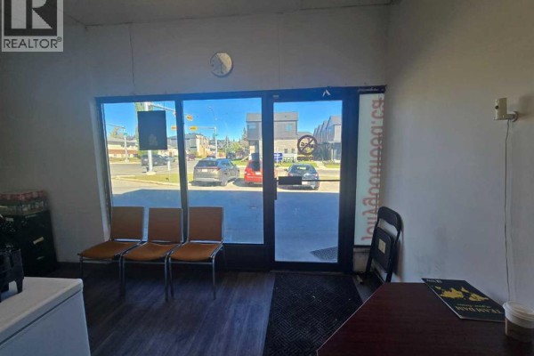 View of street through glass front doors and windows. - 3315 26 Avenue Sw, Calgary