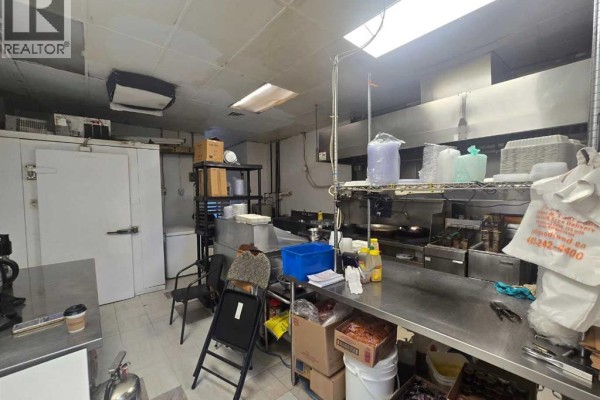 Commercial kitchen with stainless steel appliances and shelving. - 3315 26 Avenue Sw, Calgary
