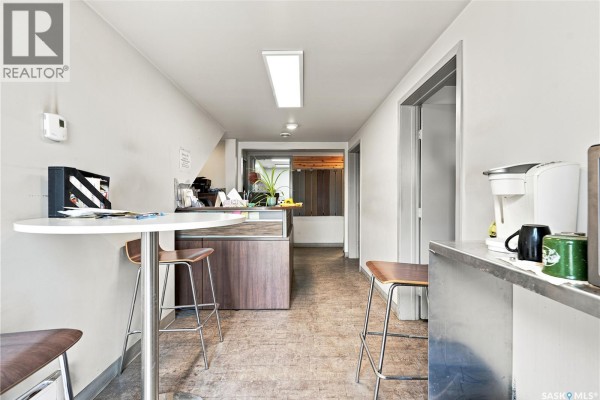 Small office break room with counter, coffee maker, table, and stools. - 3315 Faithfull Avenue, Saskatoon