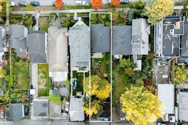 Top-down aerial view of 3315 Victoria Drive, highlighting the property's length and its position on a densely populated street. - 3315 Victoria Drive, Vancouver