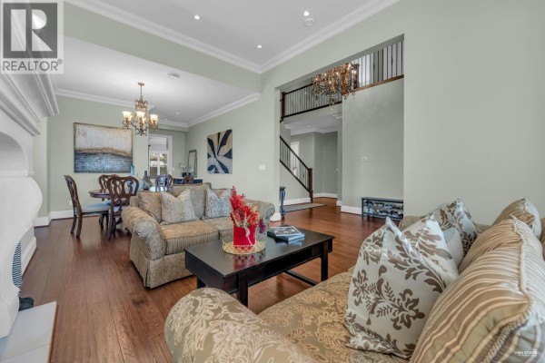 View from the living room showing the dining area, staircase, and hallway of the house. - 3317 Bentinck Place, Richmond