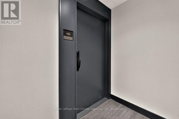 Dark grey apartment door with a sign indicating unit number 332. - 332 - 405 Dundas Street W, Oakville