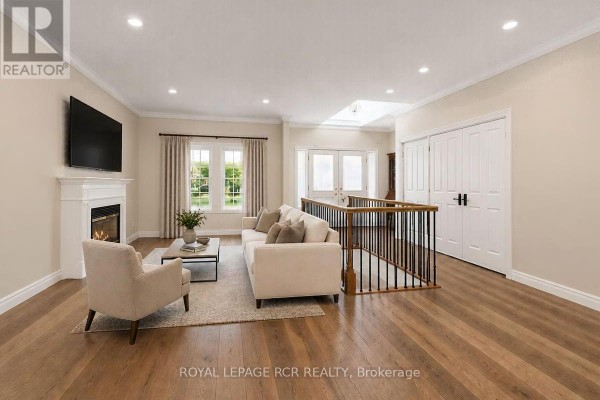 Interior view of the front entryway with white double doors, a wooden bench, and tiled flooring. - 332 King Street, East Gwillimbury