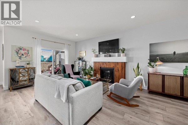 Entryway with a white front door, shoe cabinet, mirror, and light wood flooring. - 3321 Hawks Crescent, Westbank