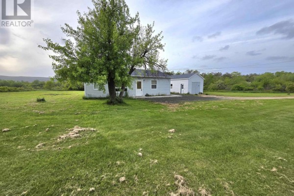 Long gravel driveway leading to a white house with outbuildings. - 3321 Highway 201, Centrelea