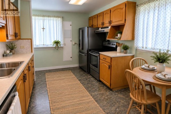 Bedroom with light wood laminate flooring, bright green walls, and a window with beige curtains. - 3322 Centre B Street Nw, Calgary