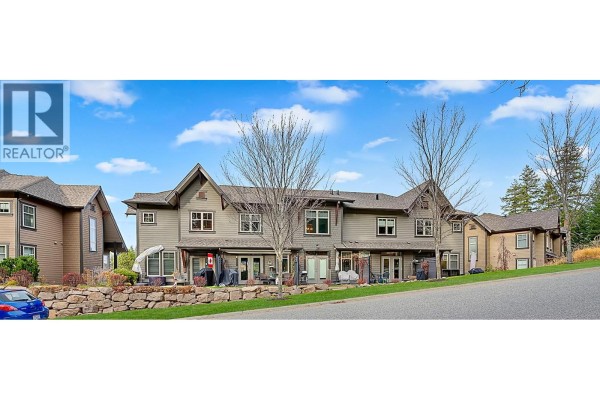 Side view of townhouse units with stone landscaping and patio areas. - 333 Longspoon Drive Unit# 33, Vernon