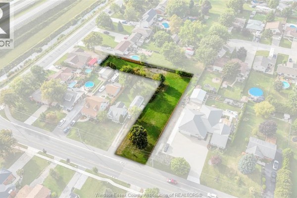 Aerial view of a land parcel outlined in black, showing a grassy yard with trees and surrounding houses. - 333 Victoria Street, Essex