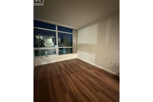 Bedroom with floor-to-ceiling windows and wood flooring. - 3333 Sexsmith Road, Richmond