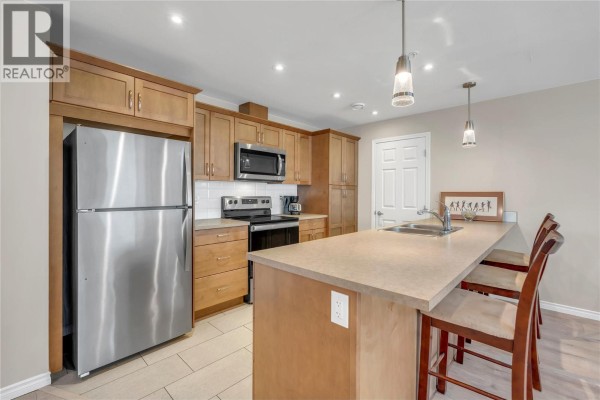 Open concept kitchen and dining area with island and living room view. - 3346 Skaha Lake Road Unit# 804, Penticton