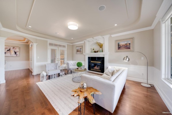 Living room featuring a fireplace, modern furniture, and large windows. - 3355 164a Street, Surrey