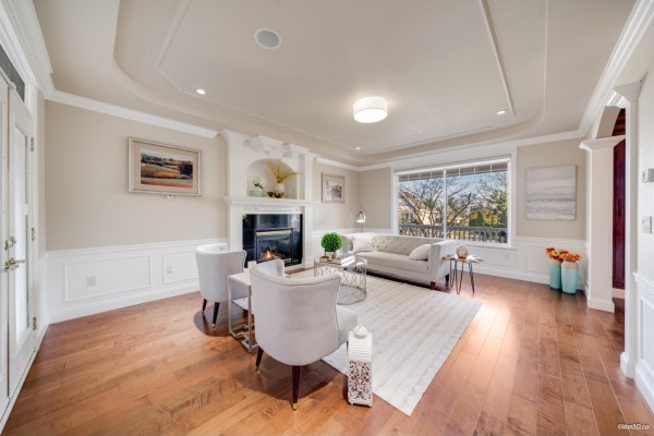 Cozy seating area with a fireplace, light-colored furniture, and natural light. - 3355 164a Street, Surrey